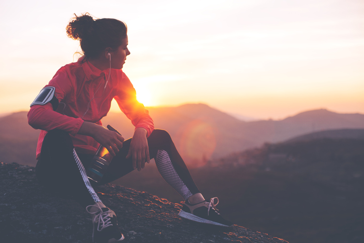 Fit woman athlete resting outdoors